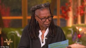 Whoopi Goldberg was passed a note on The View Monday after making a statement about Donald Trump
