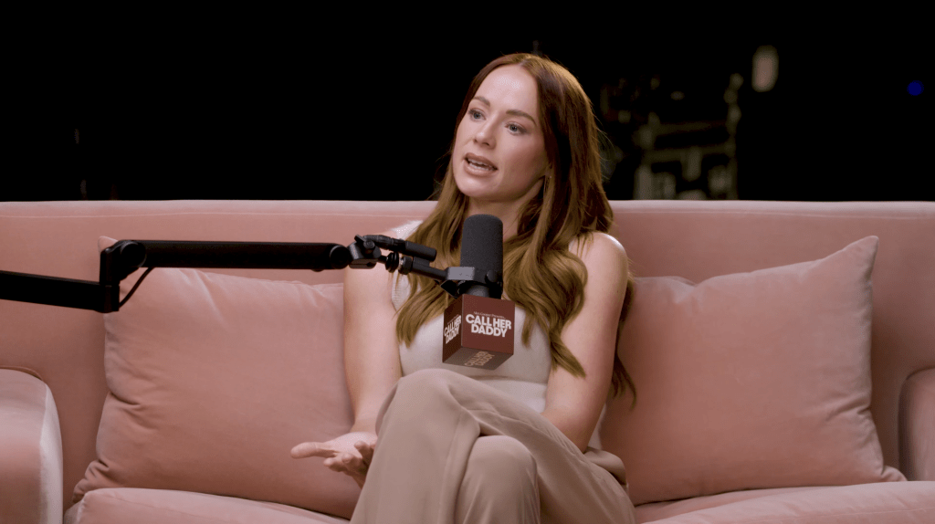 Whitney Leavitt speaking into a "Call Her Daddy" microphone.