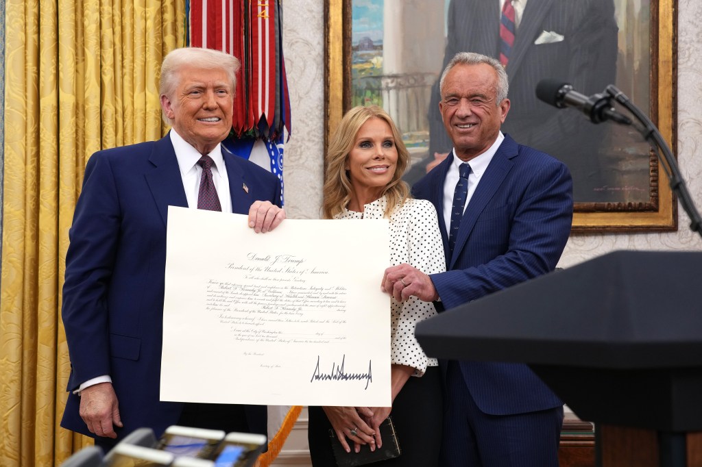 President Donald Trump, Robert F. Kennedy Jr., and Cheryl Hines pose after Kennedy was sworn in as Secretary of Health and Human Services.