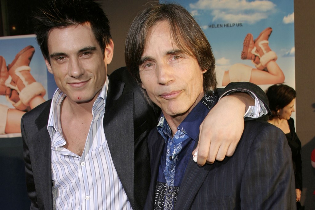 Jackson Browne with his son Ethan Browne on the red carpet, smiling with Ethan's arm around his father.