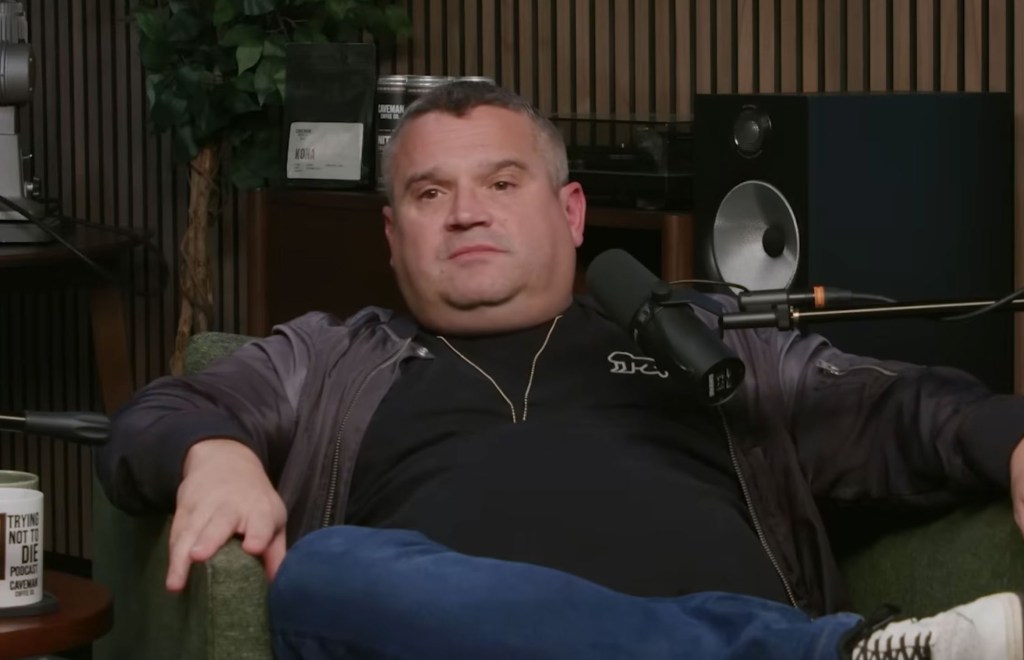Louis Osbourne, son of Ozzy Osbourne, sitting in an armchair with a microphone in front of him.