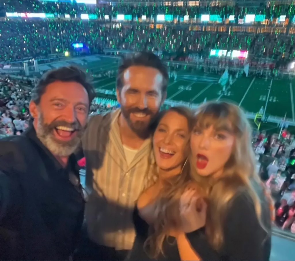 Hugh Jackman, Ryan Reynolds, Blake Lively, and Taylor Swift posing at a football game.