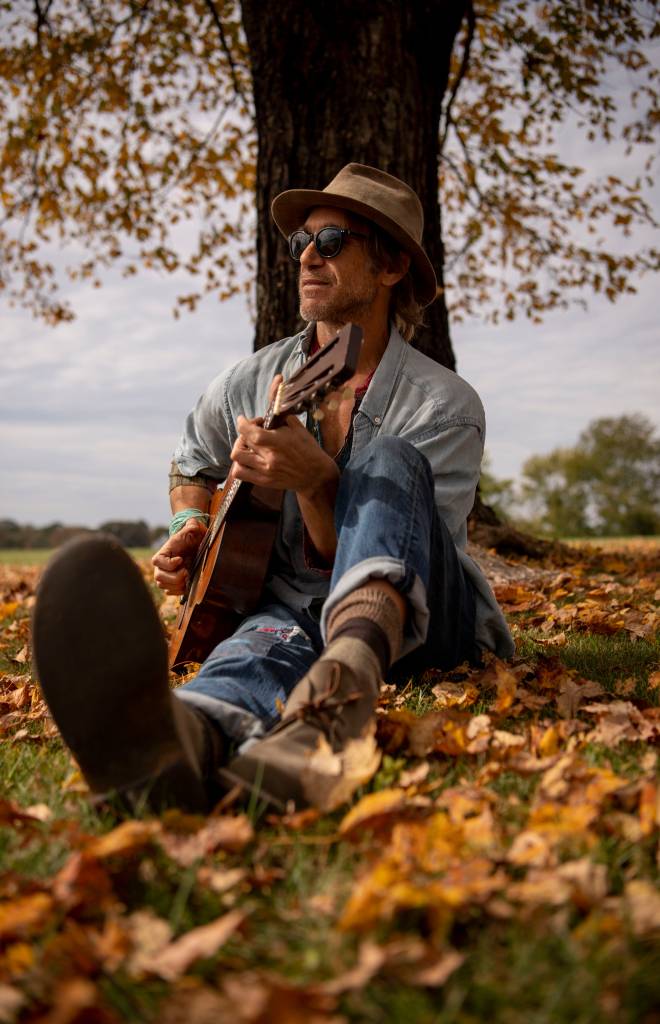 Todd Snider plays guitar at his home in Nashville.