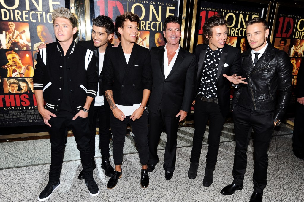 One Direction members with Simon Cowell at the premiere of 'One Direction: This Is Us.'