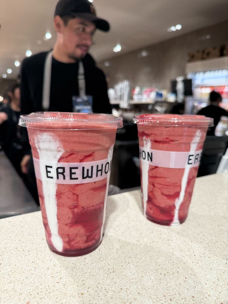 Two Erewhon Strawberry Glaze Skin Smoothies on a counter.