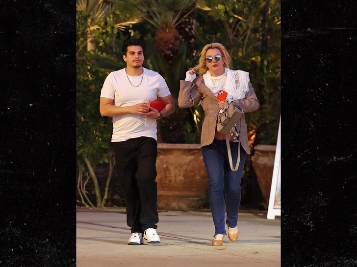 Britney Spears gets a hand with her belongings as she departs the Westlake Village property, dressed in a blazer, high heels, and sunglasses.