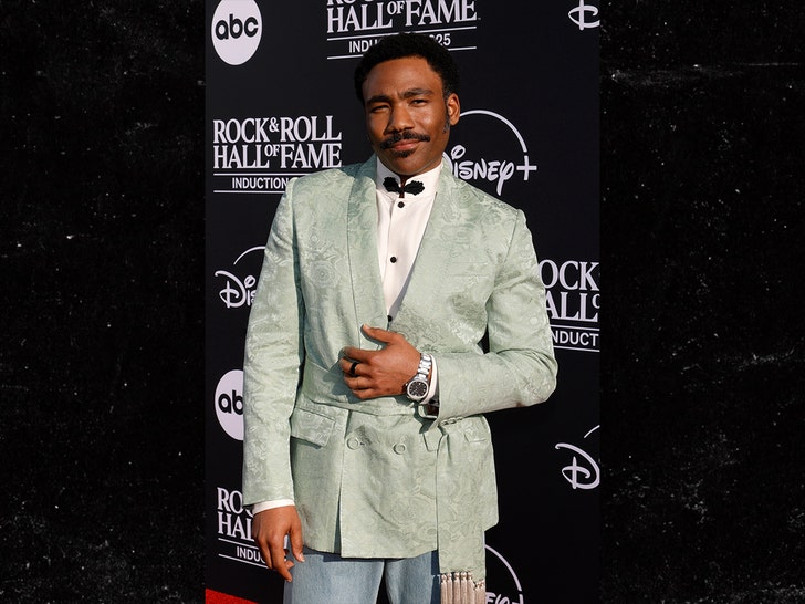 Donald Glover (Childish Gambino) arrives in a mint smoking jacket at the 2025 Rock & Roll Hall of Fame.