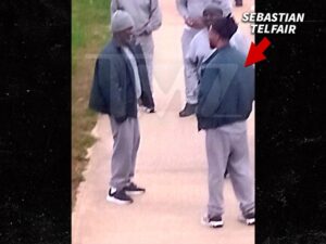 Photo, via TMZ, purportedly showing Sean “Diddy” Combs speaking with Sebastian Telfair in the yard at FCI Fort Dix.