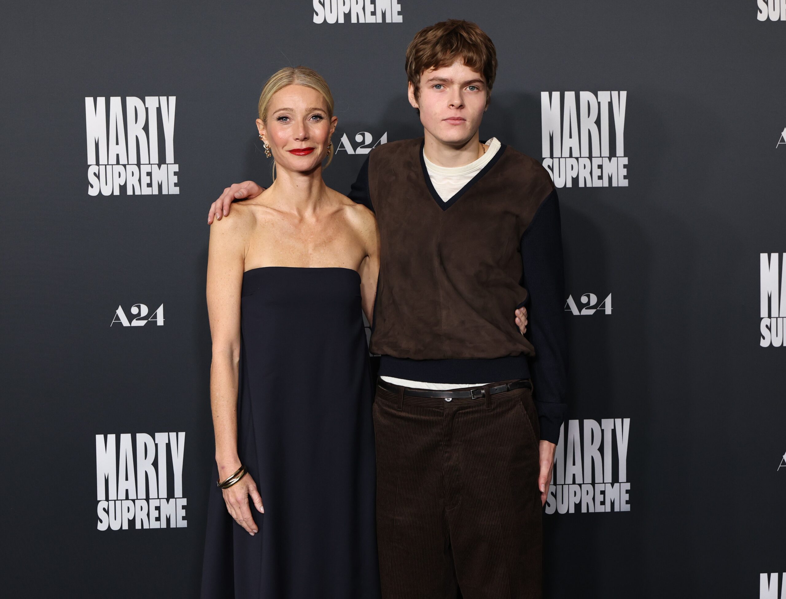 Gwyneth Paltrow and her son Moses Martin pose together on the red carpet at the Los Angeles premiere of 'Marty Supreme'.