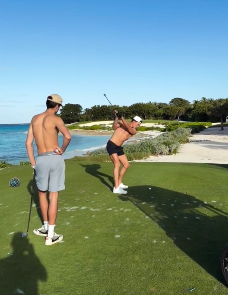 Tom Brady tees off shirtless at Bakers Bay while his son Jack watches on Christmas Eve.