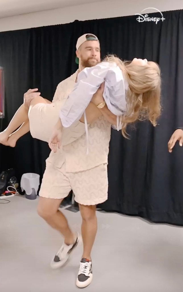 Travis Kelce carrying Taylor Swift.