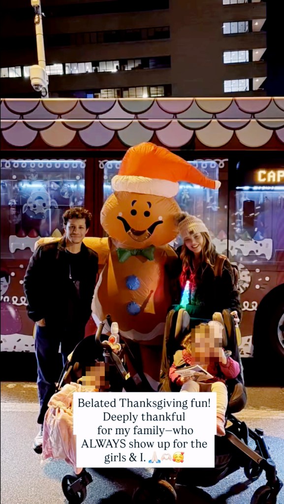 David Del Rio with his wife, Katherine, and their two daughters in front of an inflatable gingerbread decoration.