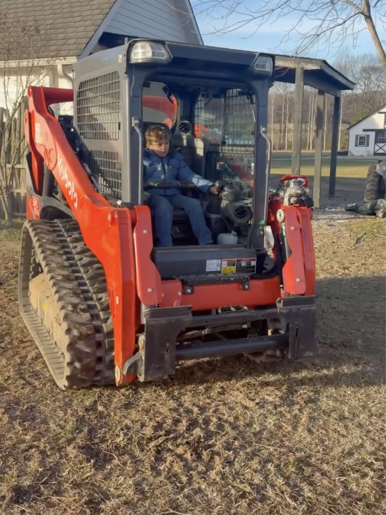 One of Jim Edmonds' twins operates a Kubota track loader during the birthday weekend.