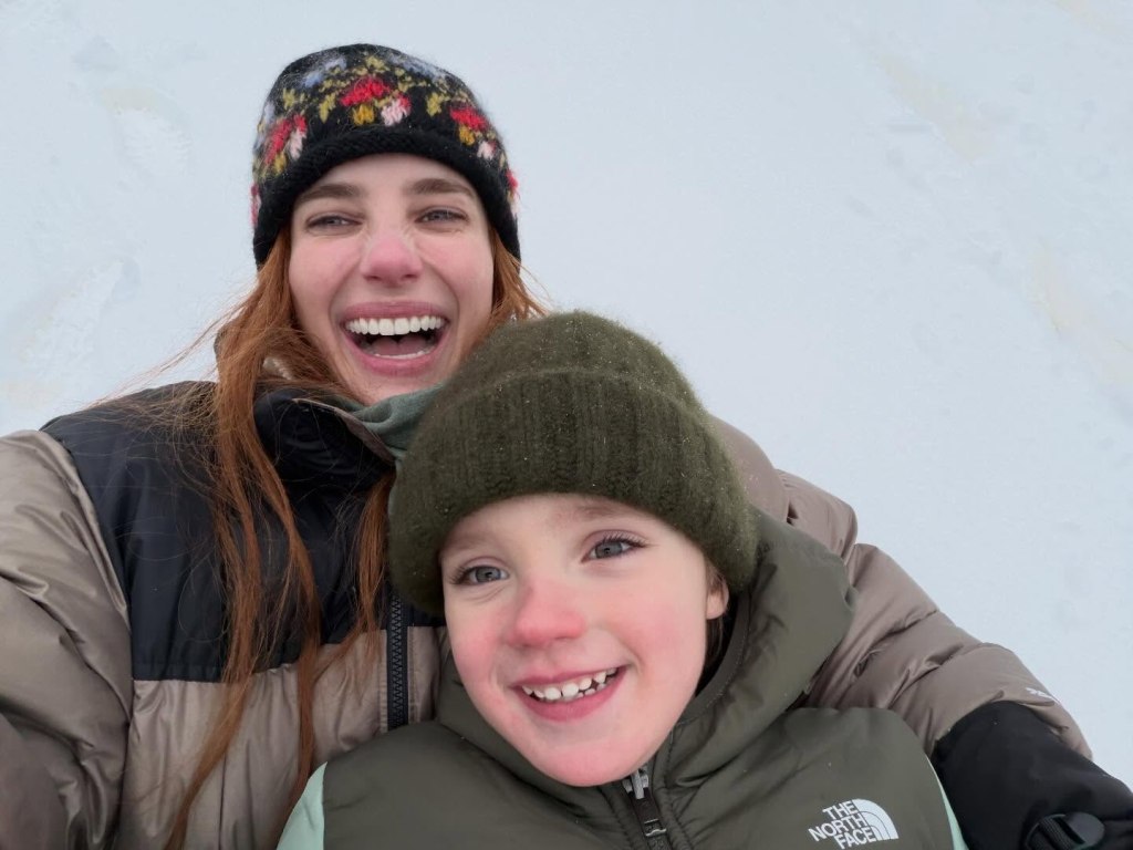 Emma Roberts and her son Rhodes smiling during a snowy getaway.