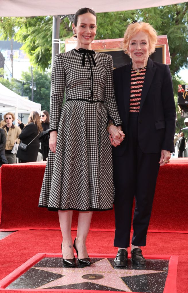 Sarah Paulson and Holland Taylor hold hands on the Hollywood Walk of Fame with Paulson's star at their feet.