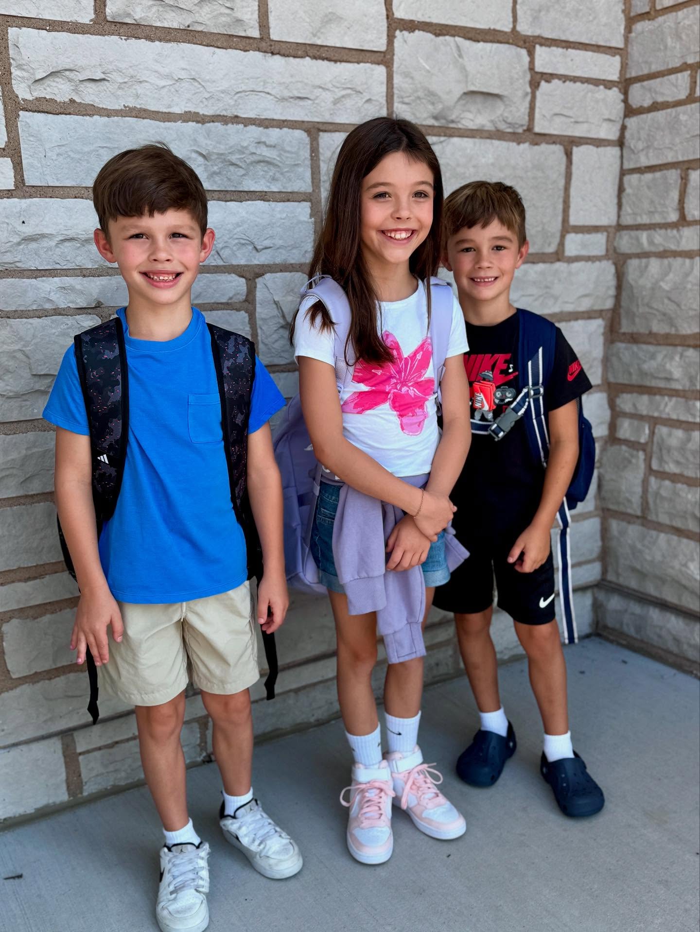 Meghan King's three children standing with backpacks, as the family transitions to a new school in Nashville.