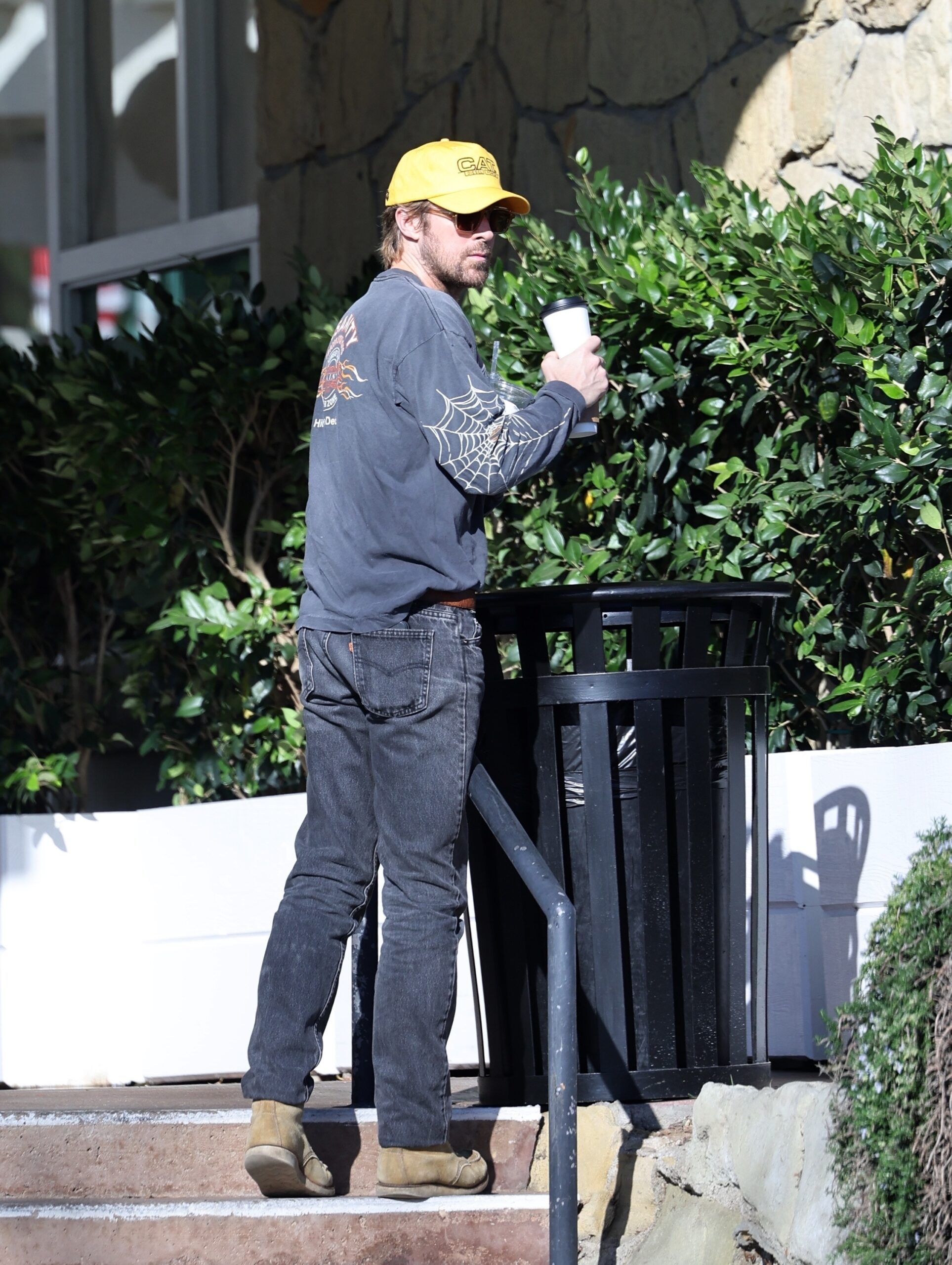 Ryan Gosling tosses trash during the low-key family errand run.