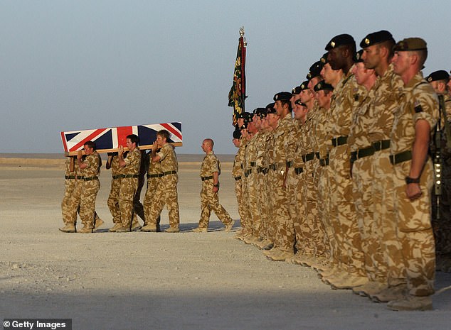 The coffin of British Army soldier L/Cpl Paul 'Sandy' Sandford is carried by fellow soldiers during his repatriation ceremony on June 9, 2007, at Camp Bastion, Helmand Province, Afghanistan.