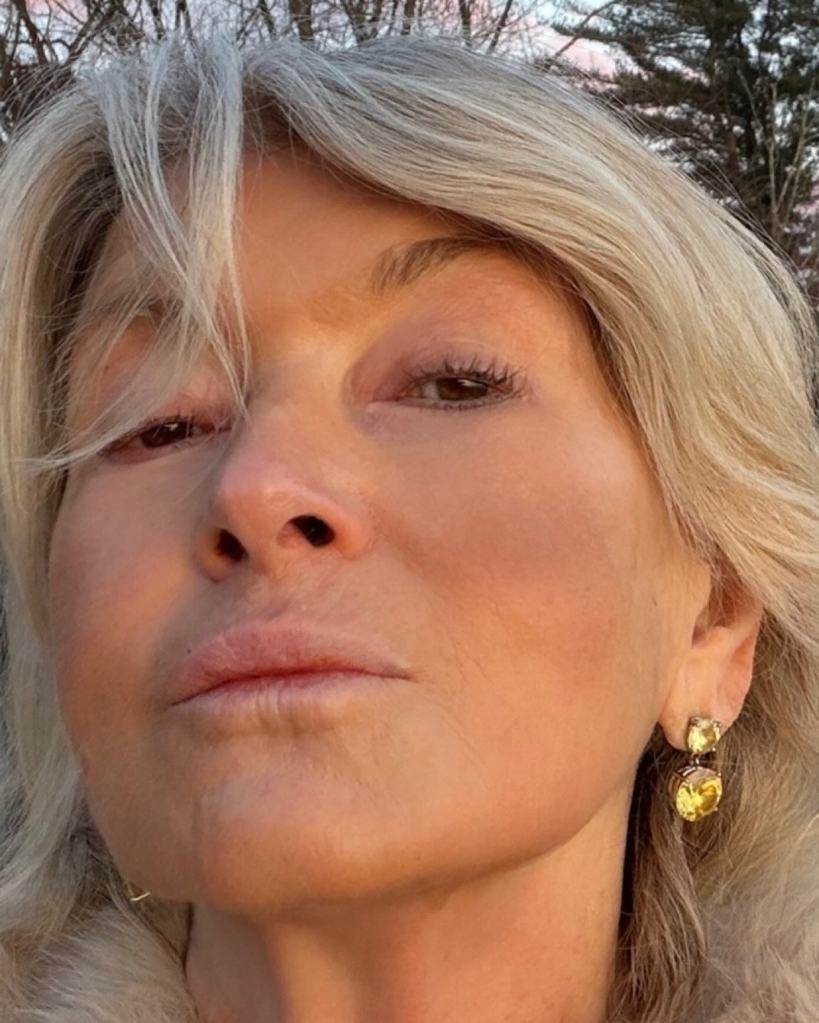Close-up of Martha Stewart looking at the camera, wearing blonde hair, and two yellow gemstone earrings.