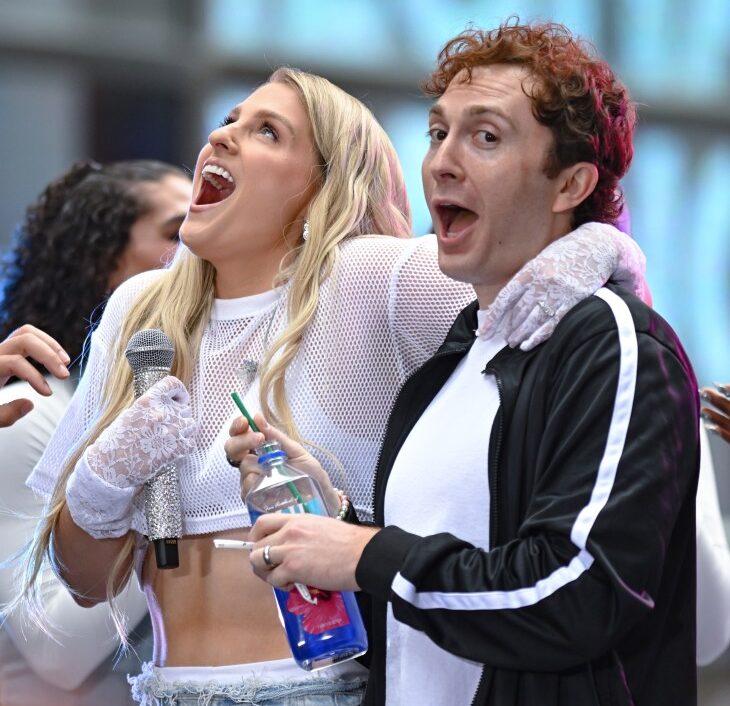 Meghan Trainor and Daryl Sabara cheer at an event.