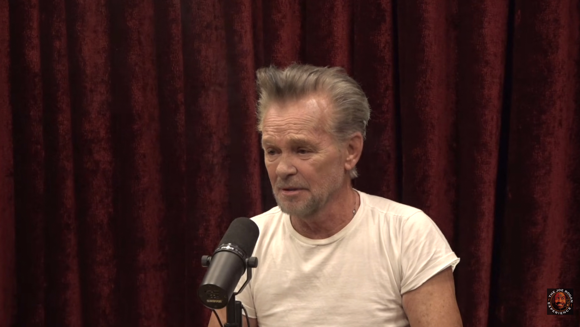 John Mellencamp speaking into a microphone.