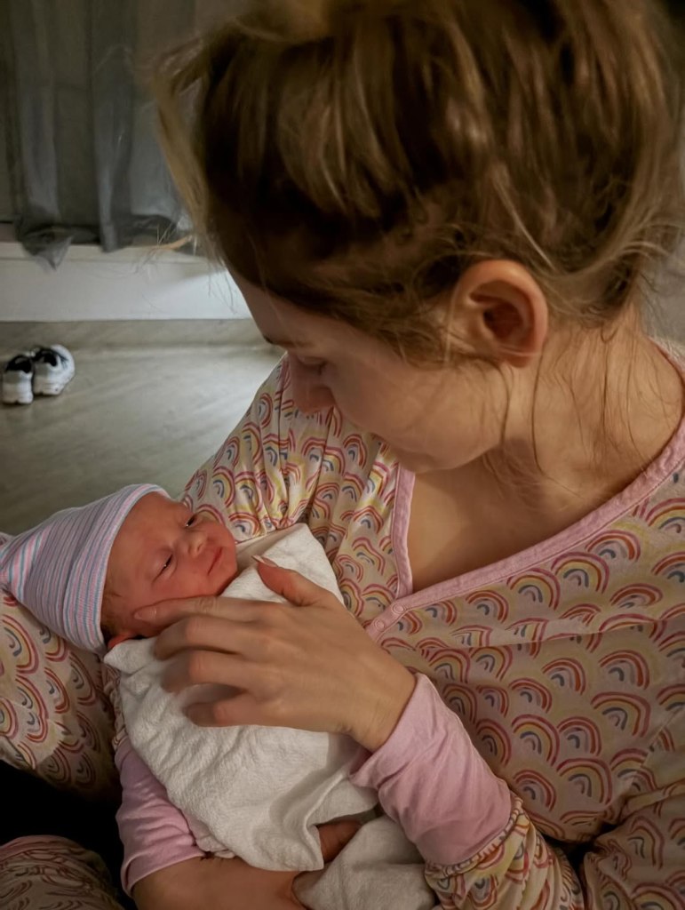 Meghan Trainor holding her newborn baby.