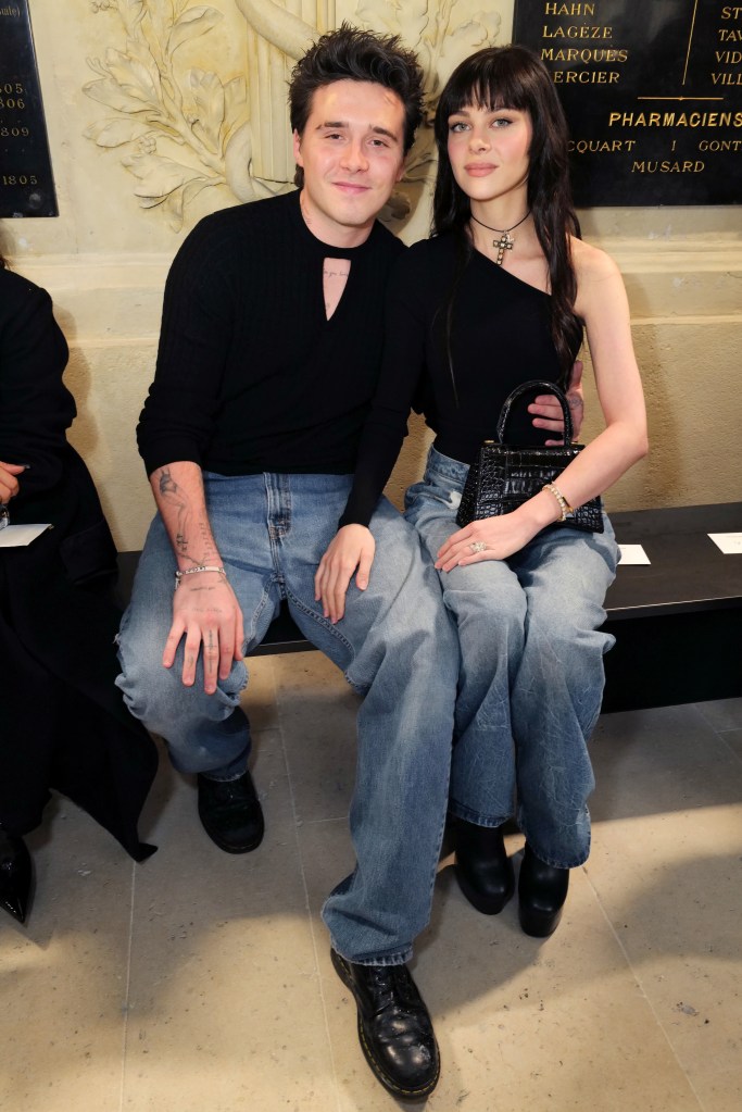 Brooklyn Beckham and Nicola Peltz Beckham seated at Victoria Beckham's SS23 Paris runway show, where the resurfaced clip was filmed.