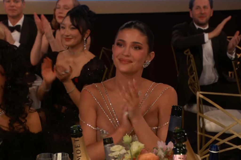Kylie Jenner applauds from the audience at the Golden Globes after Chalamet's speech.