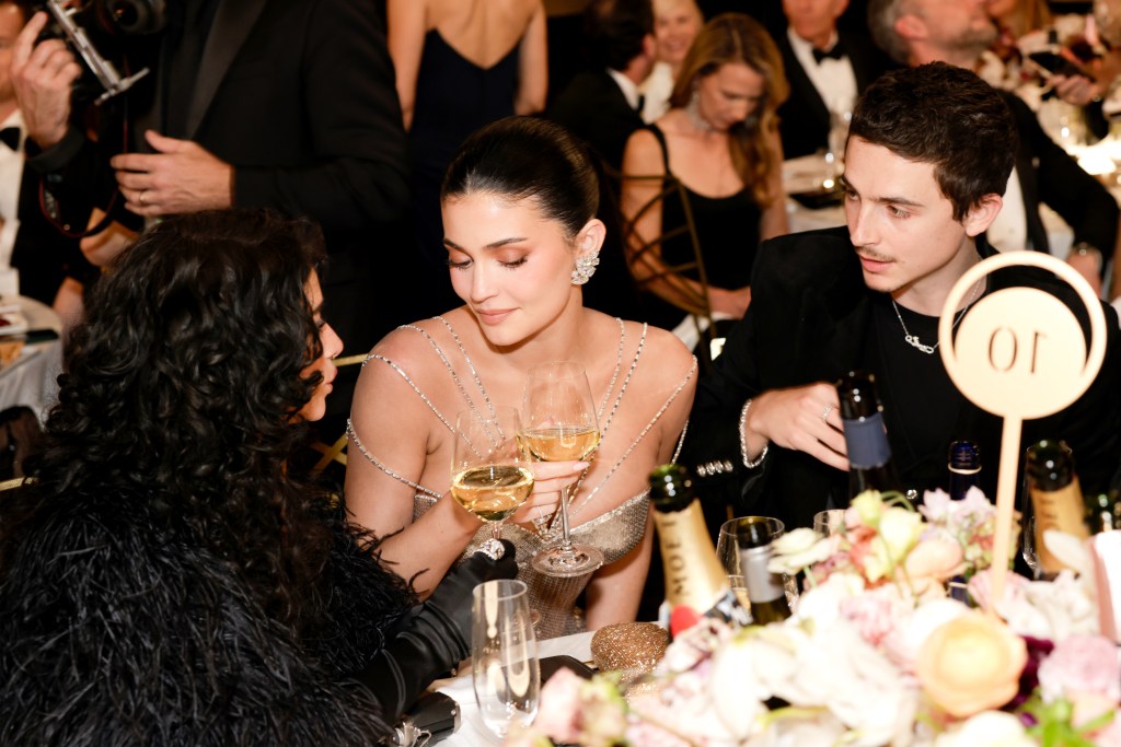 Kylie Jenner embraces Odessa A'zion near Timothee Chalamet following his Golden Globes win.