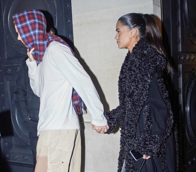 Romeo Beckham and Kim Turnbull holding hands while leaving Hotel Costes in Paris.