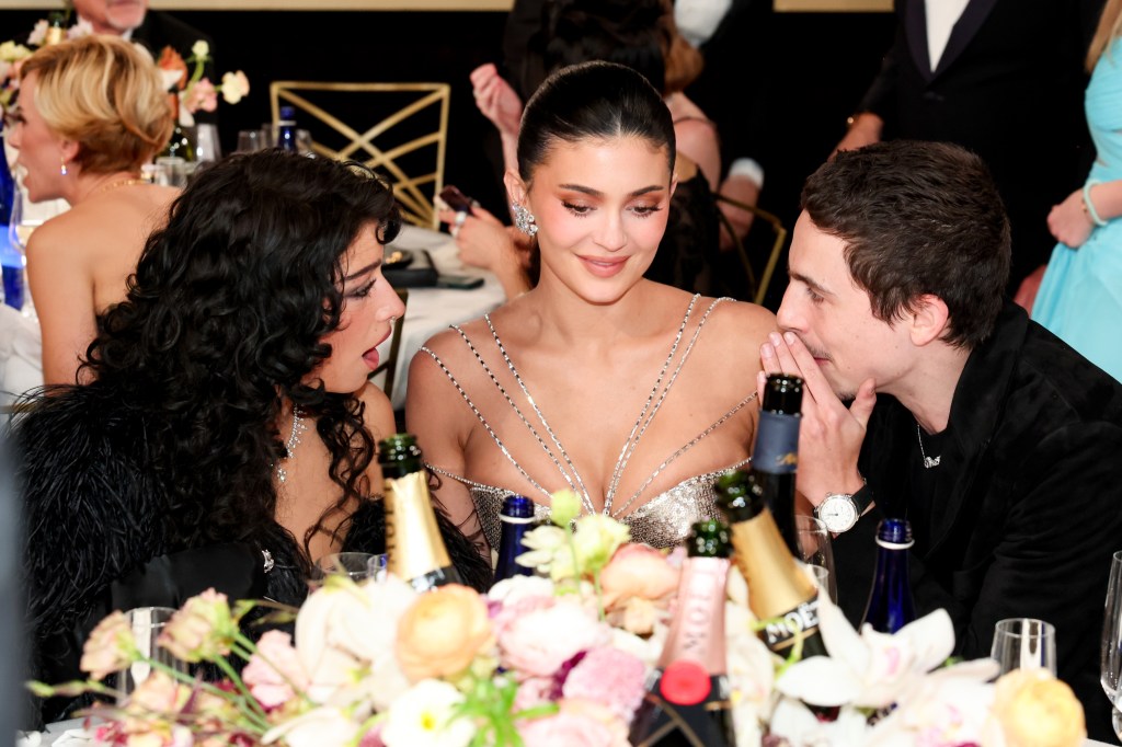Odessa A'zion, Kylie Jenner, and Timothee Chalamet seated together during the Golden Globes, appearing friendly.