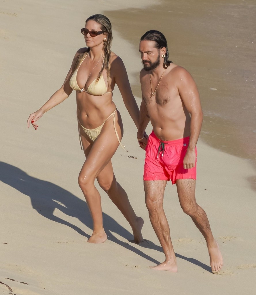 Heidi Klum and Tom Kaulitz holding hands while walking on Gouverneur Beach in Saint-Barth.
