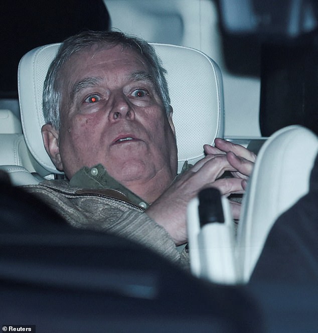 Prince Andrew slumped in the back of a car as he is driven away from Aylsham Police Station