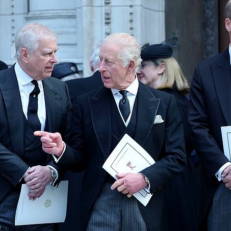 The ex-Duke of York Andrew Mountbatten-Windsor (left) speaking to King Charles (centre) at the Duchess of Kent's funeral in September last year - while Prince William (right) stands apart - Daily Mail US