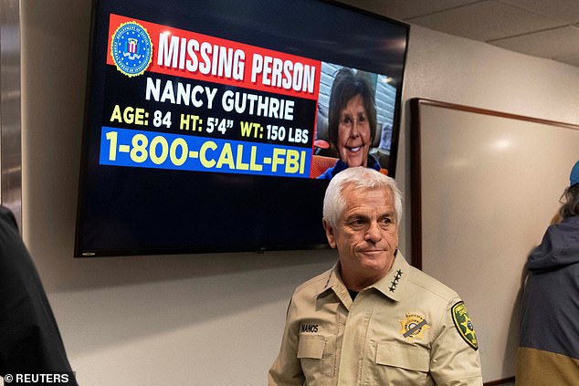 Pima County Sheriff Chris Nanos speaks in front of a missing-person display for Nancy Guthrie.