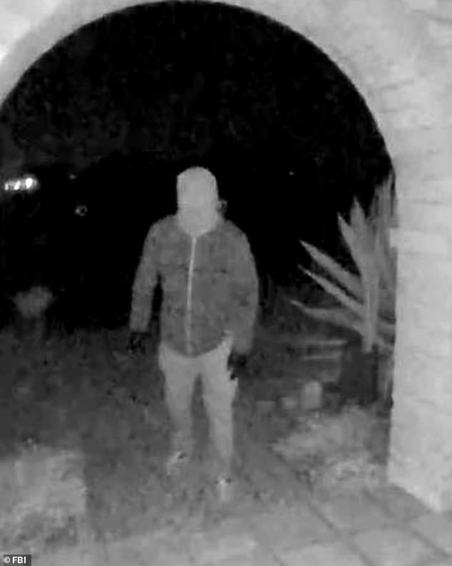 Doorbell-camera still of an unidentified masked person at Nancy Guthrie's home, as released by authorities.