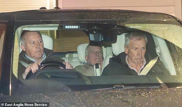 Andrew Mountbatten-Windsor lowering himself in his seat to avoid cameras as the car departs Aylsham Police Investigation Centre