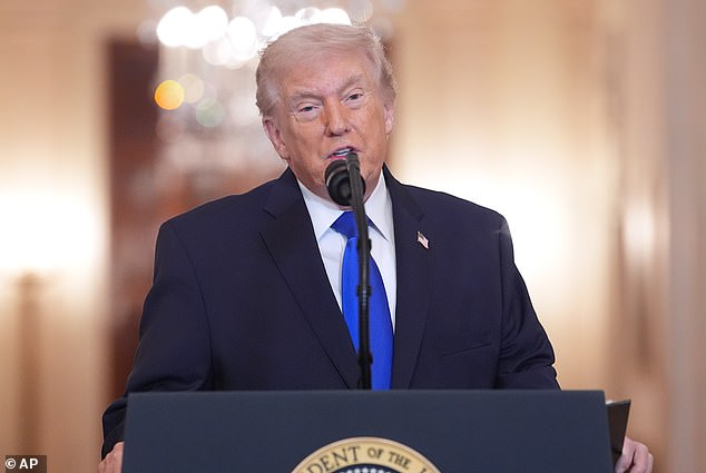 President Donald Trump speaks at a podium after inviting Team USA to the White House.
