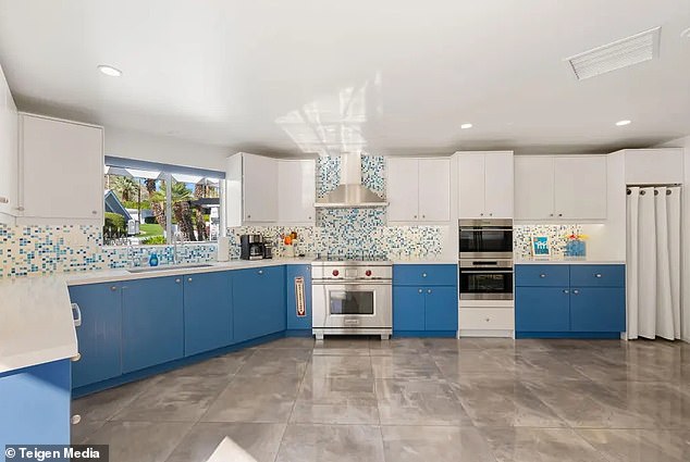 Remodeled mid-century kitchen in bold blue cabinetry at the Doll House