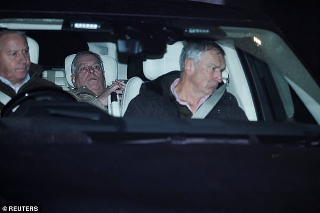 Prince Andrew in the back seat of a car leaving a Norfolk police station after being released under investigation
