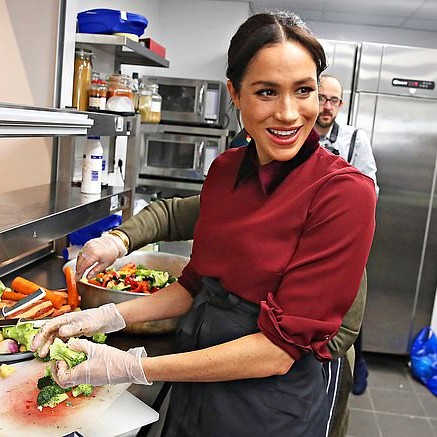 Meghan, in her first solo project as a working royal, championed the charity Hubb Community Kitchen, pictured prepping food there in 2018 - Daily Mail