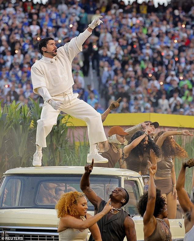 Bad Bunny stands atop a vehicle as dancers fill the field during his Spanish-language Super Bowl halftime set