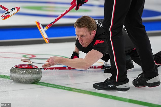 Marc Kennedy releasing a curling stone near the hog line, where contact must cease