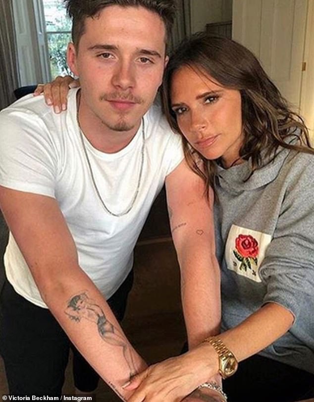 Brooklyn Beckham with mother Victoria Beckham; he later covered a 'mama's boy' tattoo