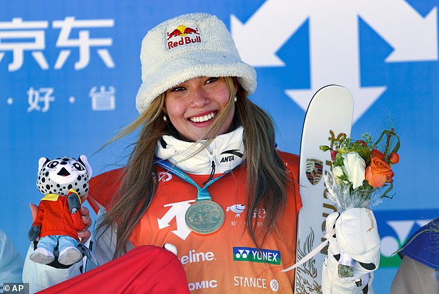Eileen Gu with medal and skis after a podium finish; a two-time Olympic champion at 22.