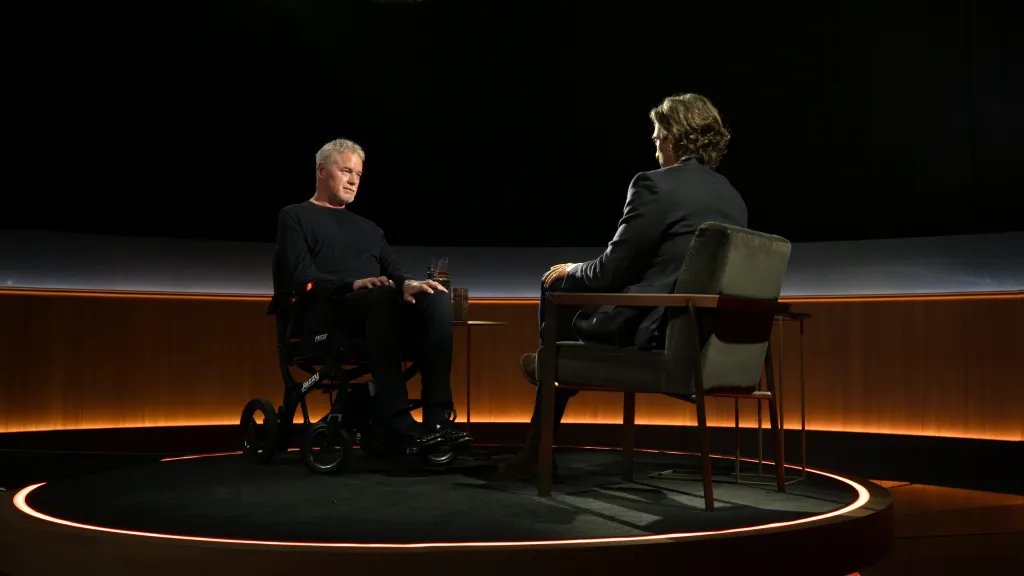 Eric Dane in a wheelchair and Brad Falchuk talking in an interview for "Famous Last Words".