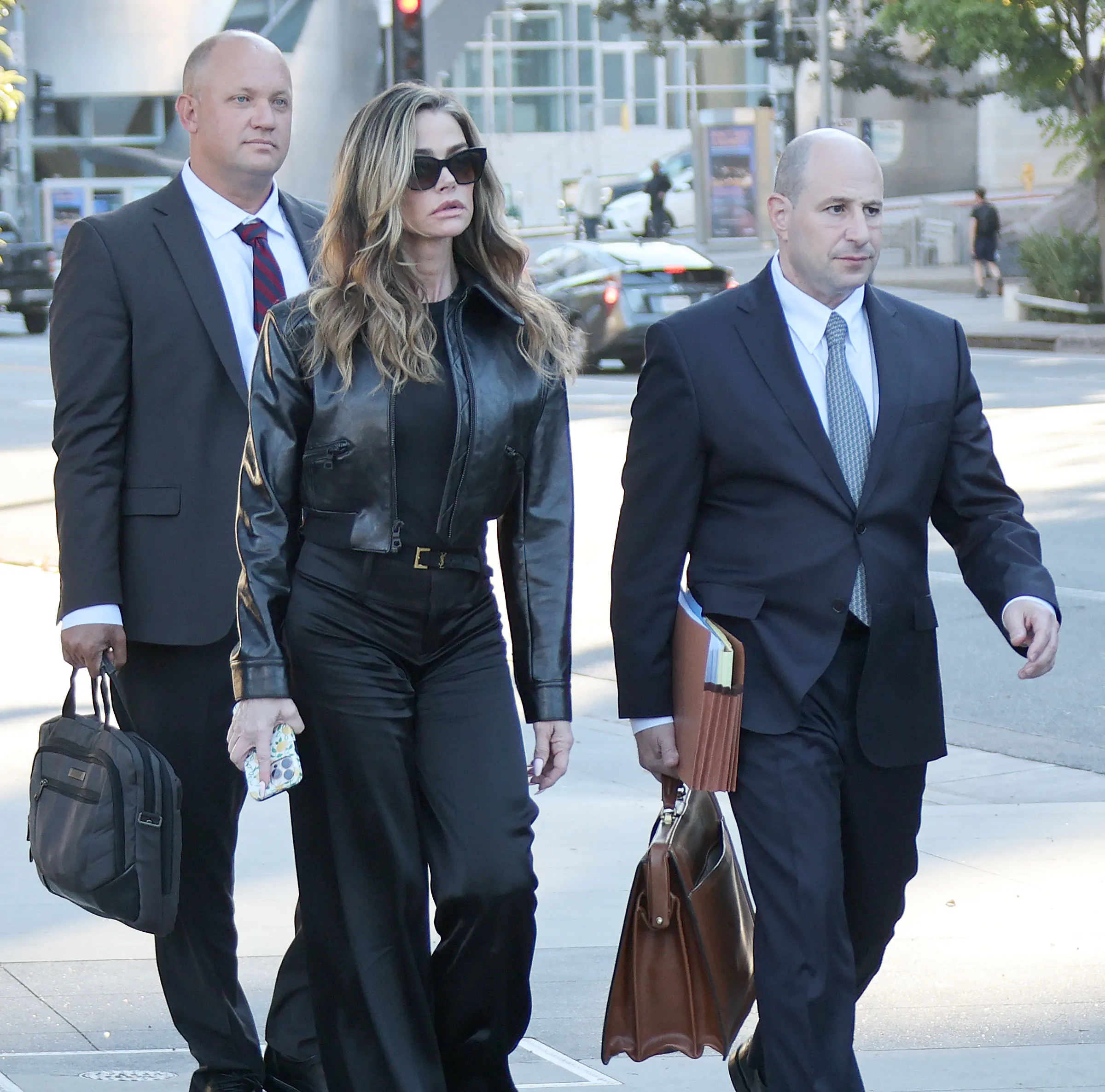 Denise Richards leaving the Los Angeles Superior Courthouse with her attorneys. - Getty Images