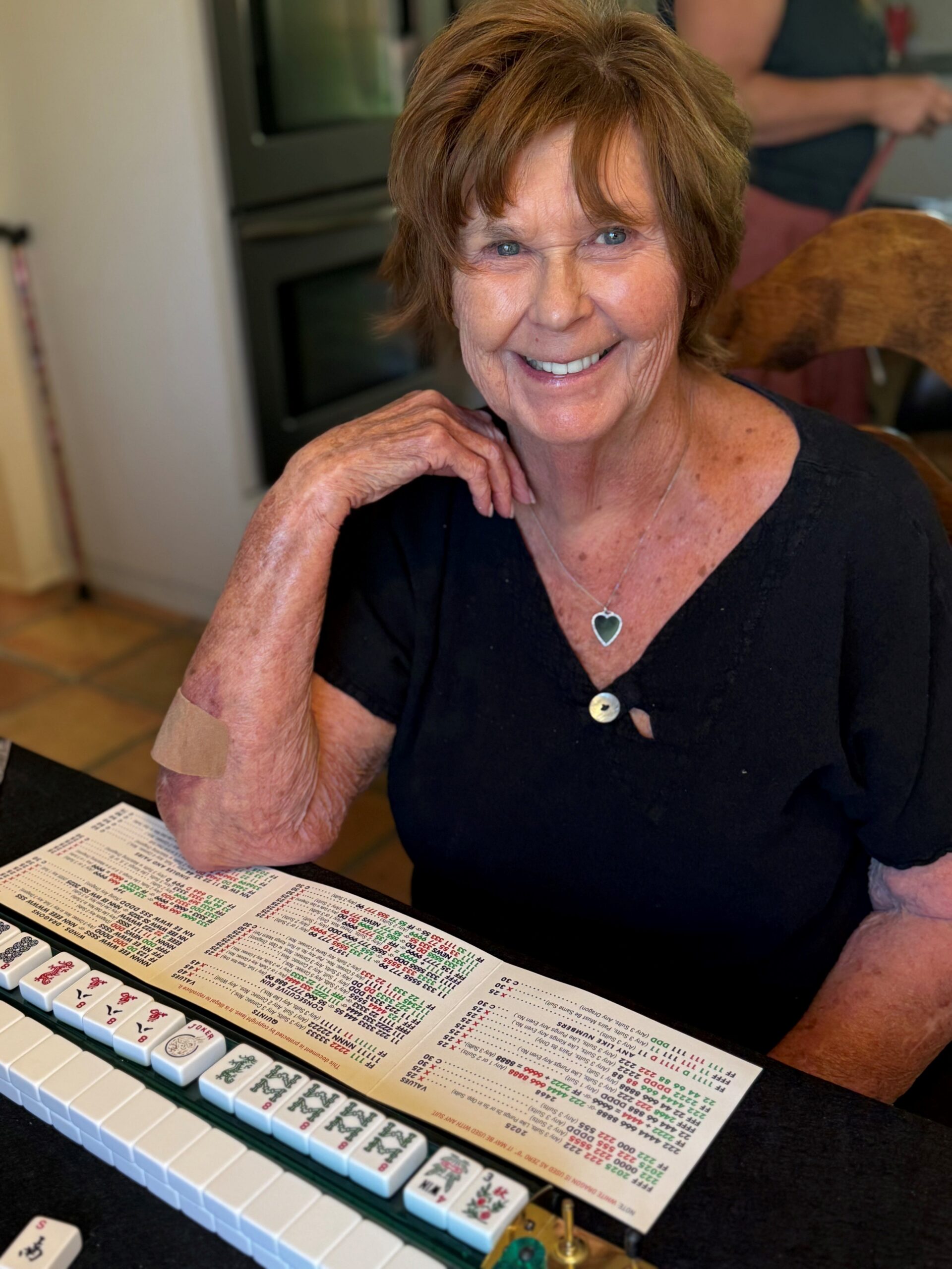 Nancy Guthrie smiling while playing Mahjong.