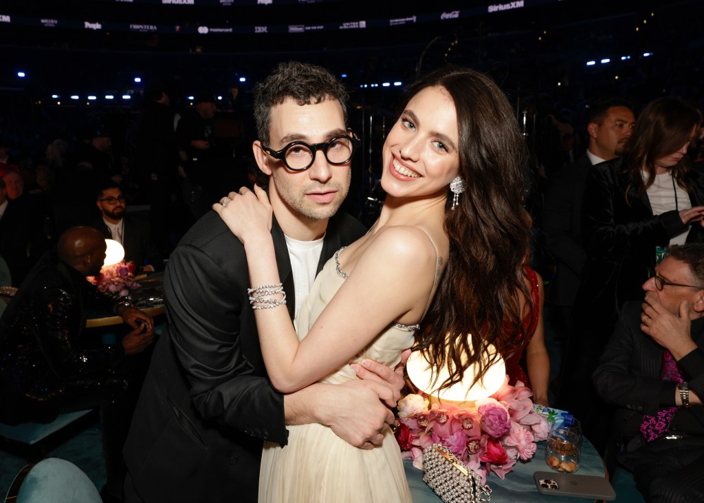Jack Antonoff and Margaret Qualley embrace and smile at the 67th Annual Grammy Awards.