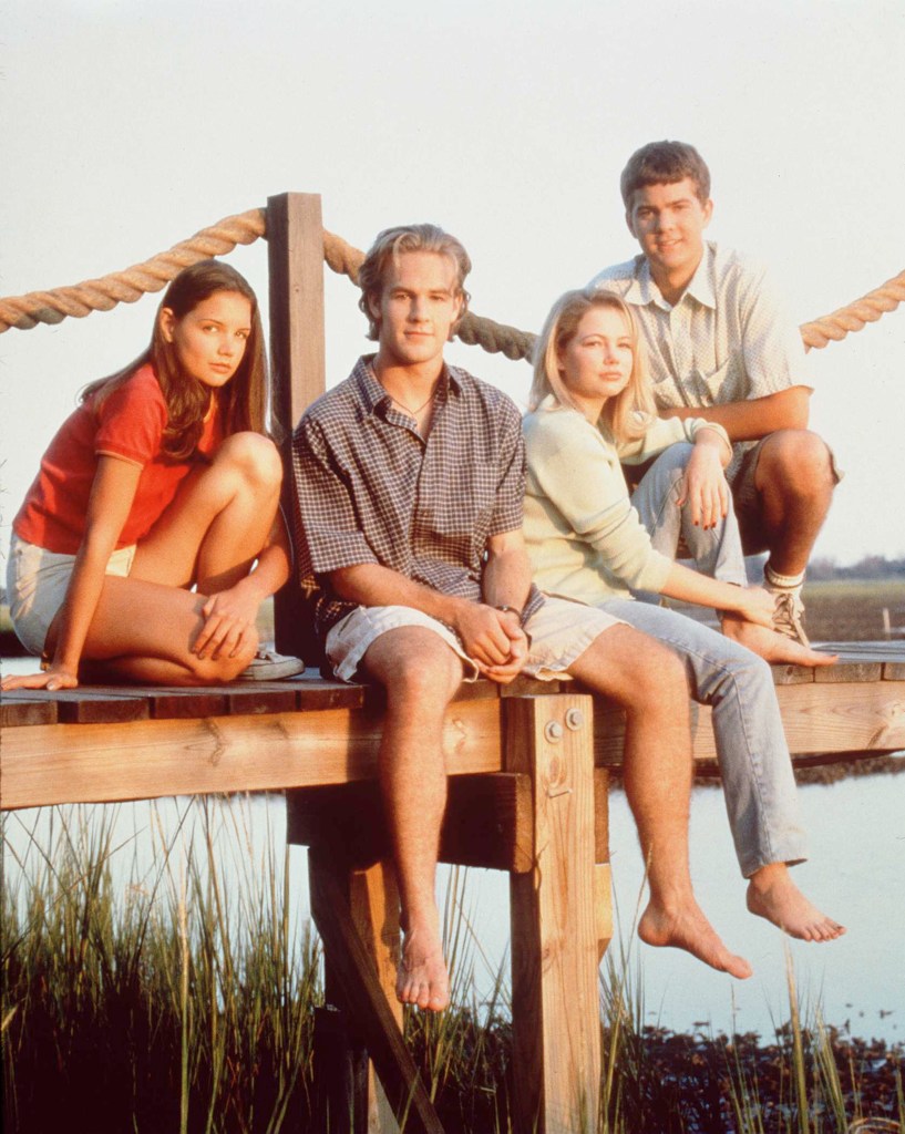 The Dawson's Creek cast sitting together on a pier.